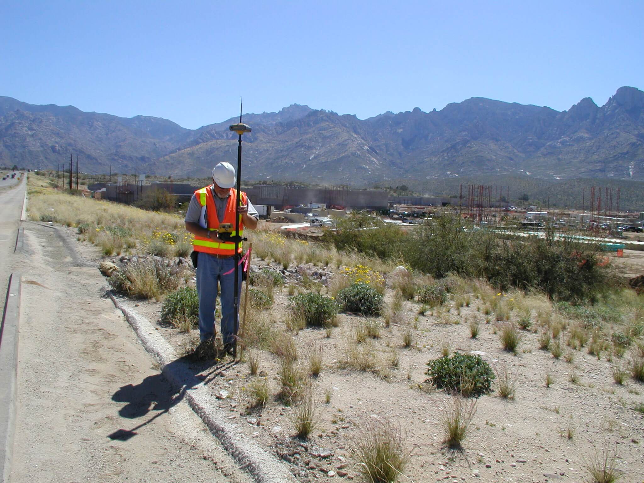 A land surveyor setting up surveying equipment